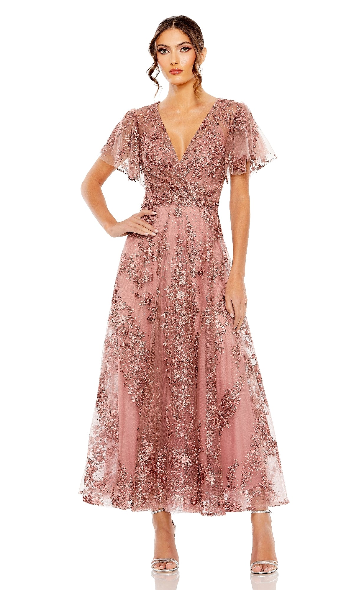 Woman wearing a mauve pink a-line dress on a white background